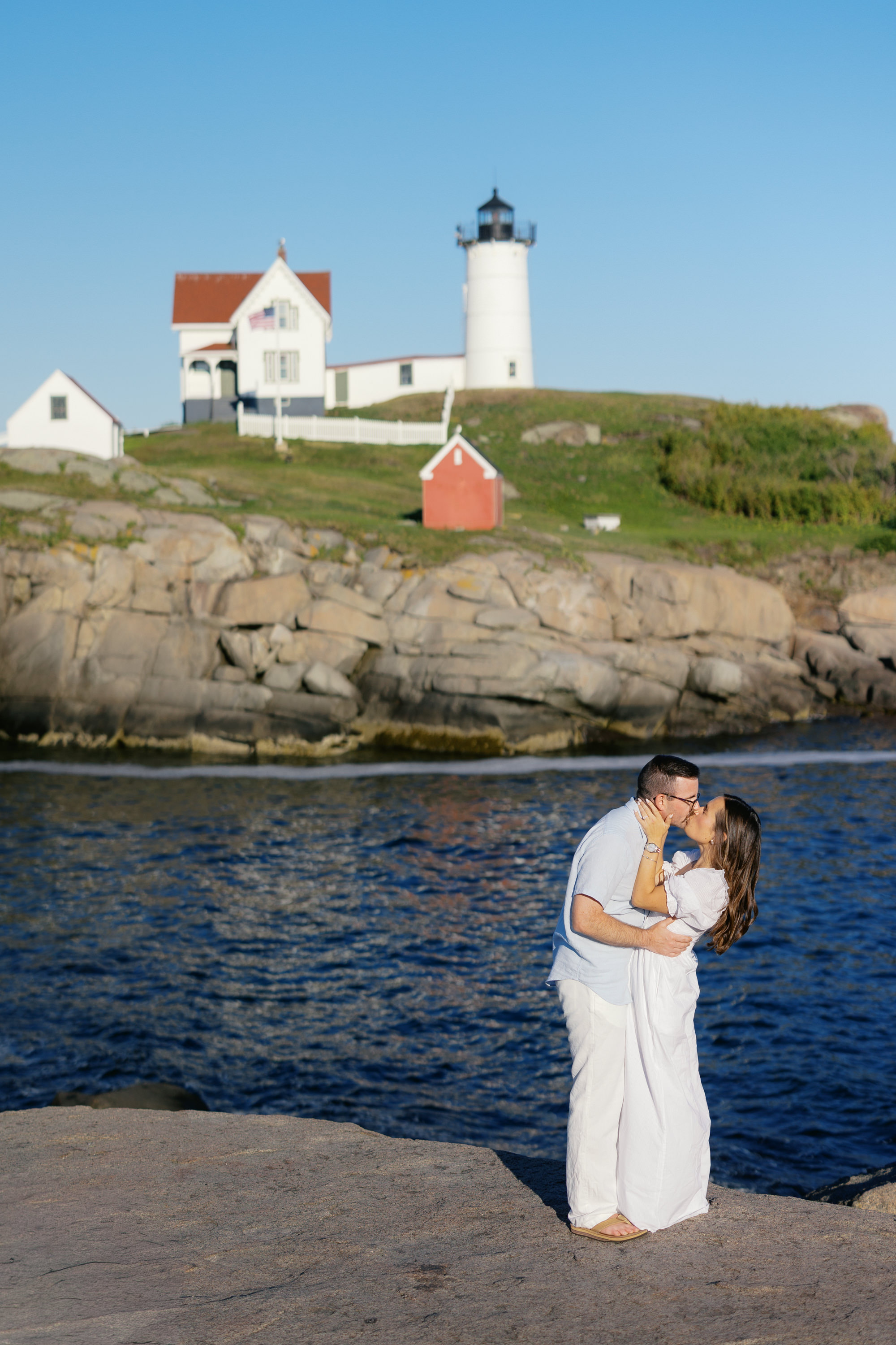 Julianne and Morgan kissing in front of Nubble Lighthouse, Maine