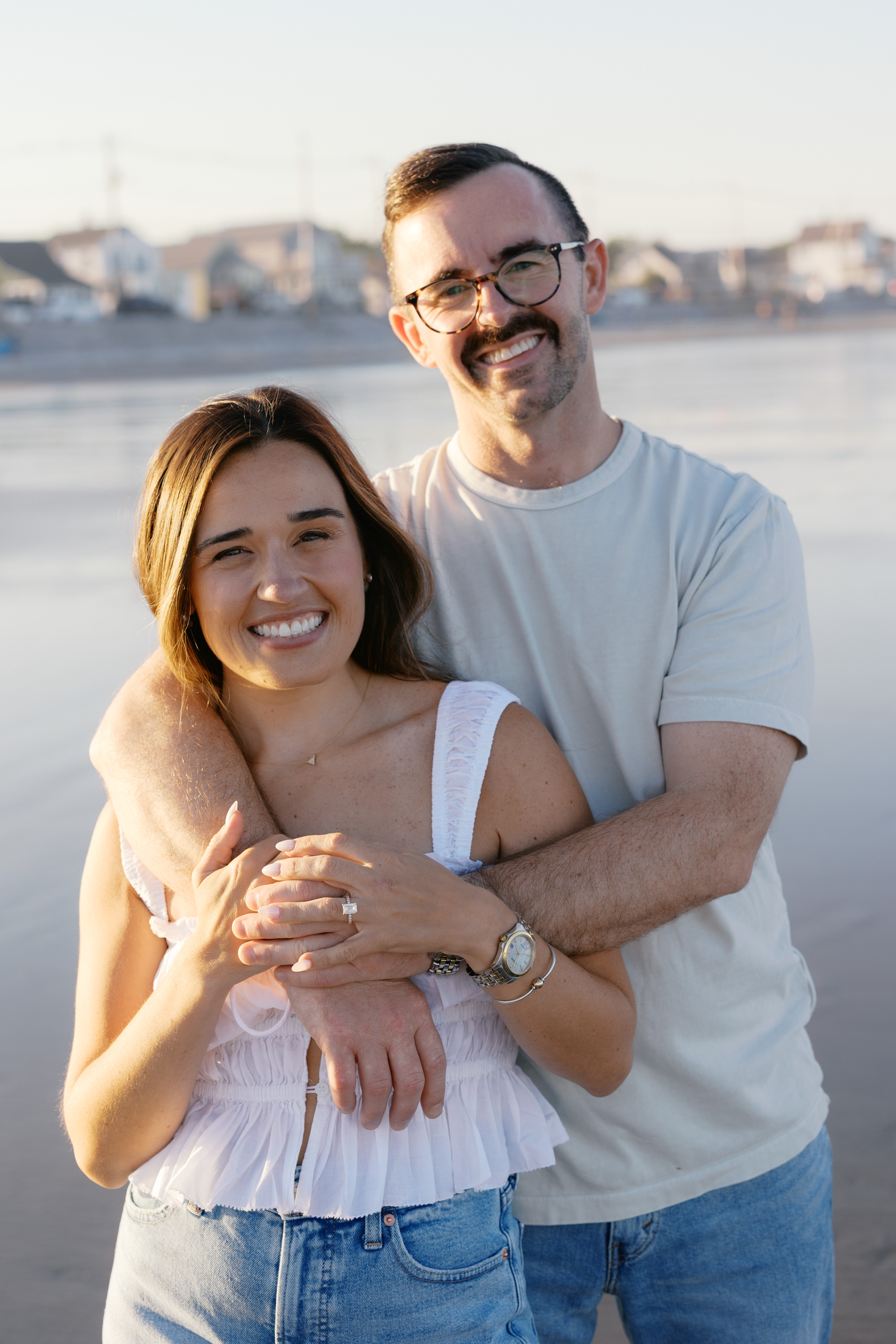Julianne and Morgan smiling together on the coast