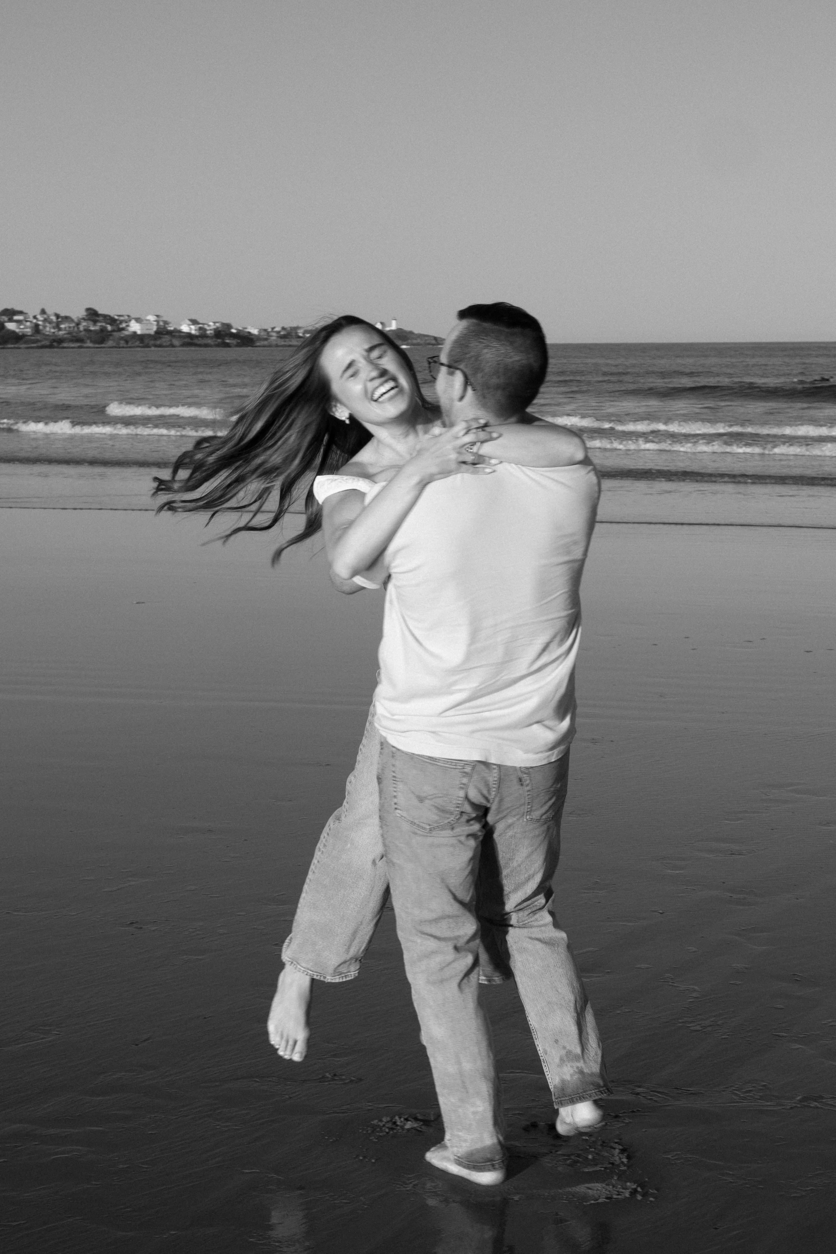 Julianne and Morgan laughing and spinning on the beach